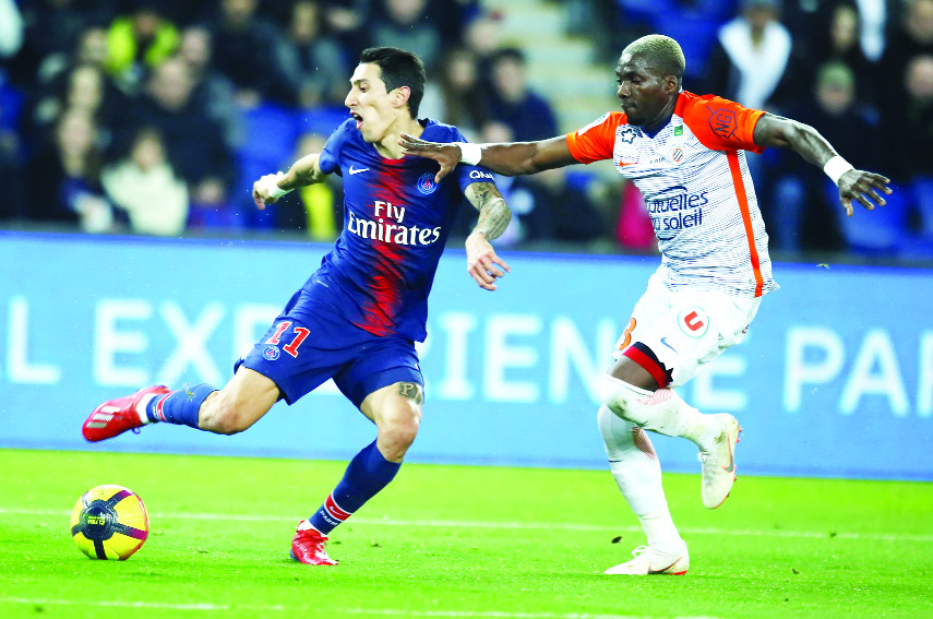 PSG's Angel Di Maria (left) scores his side's second goal during the French League One soccer match between Paris Saint Germain and Montpellier at the Parc des Princes stadium in Paris, France on Wednesday.