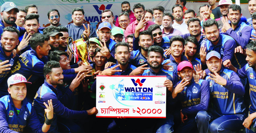 Members of Bangladesh Police Baseball team, the champions of the Walton 6th National Men's Baseball Competition with the guests and officials of Bangladesh Baseball-Softball Association pose for a photo session at the Paltan Maidan on Friday.