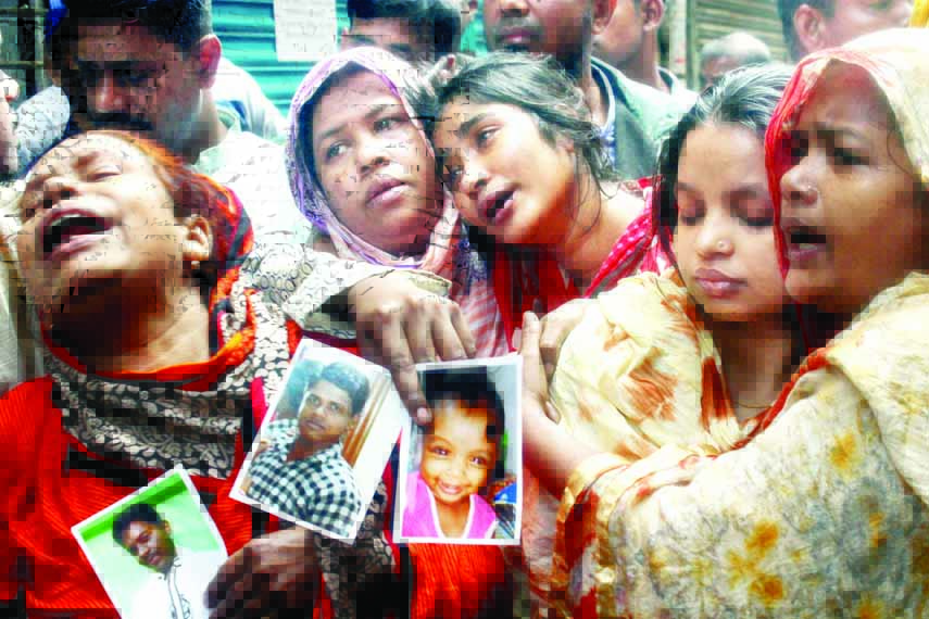 Relatives with portraits of Chawkbazar fire victims killed or missing were seen wailing at Churihatta area on Saturday.