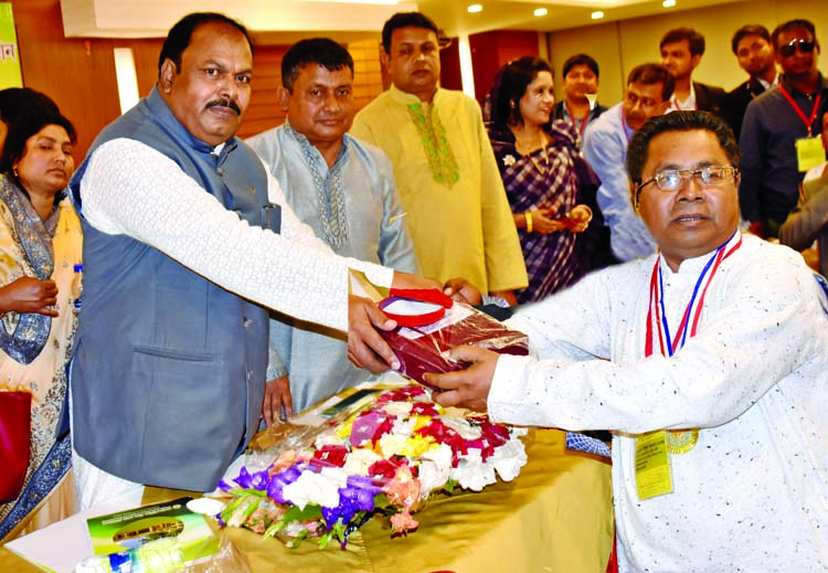State Minister for Primary and Mass Education Zakir Hossain handing over gold medal to the successful Chairman of 11 No. Durgapur Union Council, Begumganj, Noakhali Abed Saiful Kalam under LGSP 'A' grade at a function organised by Bangladesh Union Pari