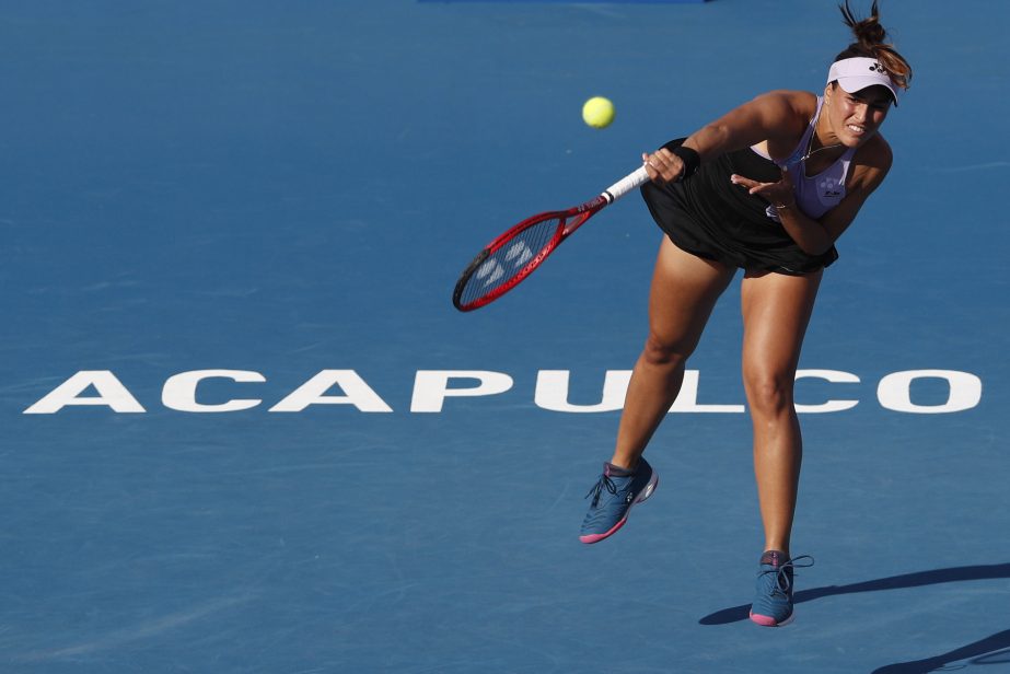 Monica Puig of Puerto Rico serves the ball to Greece's Maria Sakkari during round one play at the Mexican Tennis Open in Acapulco, Mexico on Monday.