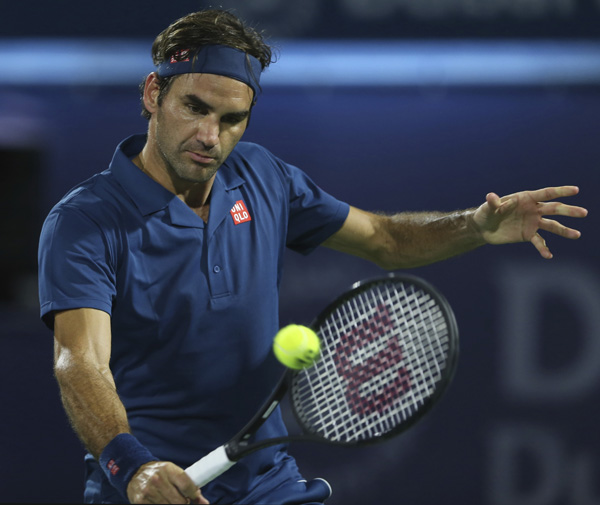 Roger Federer of Switzerland returns the ball to Philipp Kohlschreiber of Germany during their match at the Dubai Duty Free Tennis Championship in Dubai, United Arab Emirates on Monday.