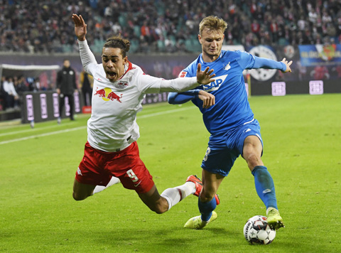 Leipzig's Yussuf Poulsen (left) challenges for the ball against Hoffenheim's Stefan Posch (right) during the German first division Bundesliga soccer match between RB Leipzig and TSG 1899 Hoffenheim in Leipzig, Germany on Monday.