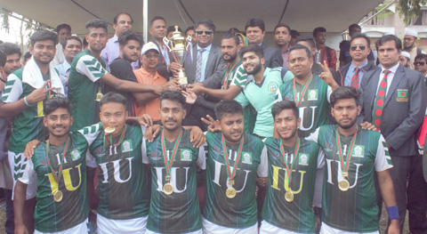 Members of Islamic University (IU) Handball team, the champions of the Inter-University Handball Competition with teachers and officials of IU pose for a photo session at the Handball Ground of IU in Kushtia on Wednesday.