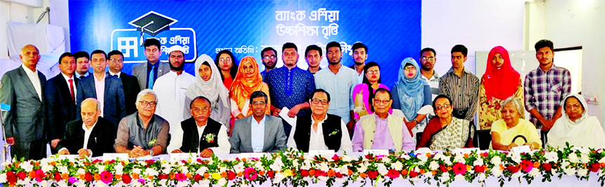 A Rouf Chowdhury, Chairman of Bank Asia Limited and Bank Asia Foundation, poses for a photo session with the winners of the Bank Asia Higher Education Scholarship-2018 at Malkhanagar Degree College Auditorium in Munshigonj recently. Zakia Rouf Chowdhury,
