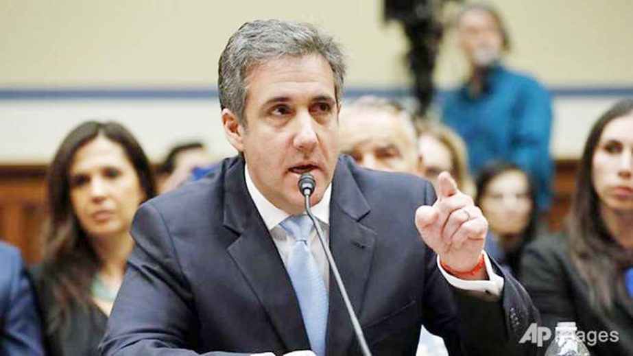 Michael Cohen, the former personal attorney of U.S. President Donald Trump, is flanked by his attorneys Lanny Davis (L) and Michael Monico Â® as he testifies before a House Committee on Oversight and Reform hearing on Capitol Hill in Washington on Wedne