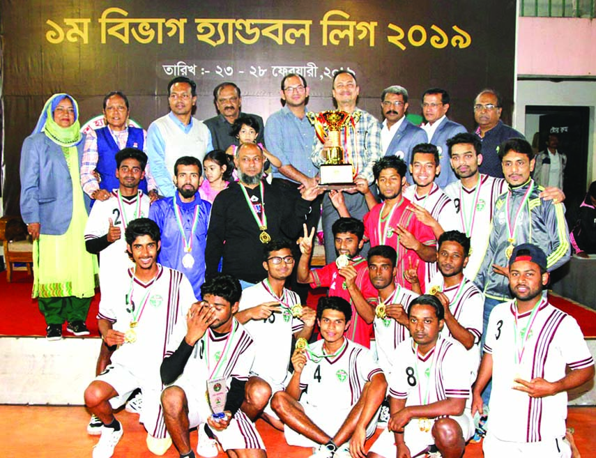 Members of Flame Boys Club, the champions of the First Division Handball (Men's) League with the guests and officials of Bangladesh Handball Federation pose for photograph at the Shaheed Captain M Mansur Ali National Handball Stadium on Thursday.