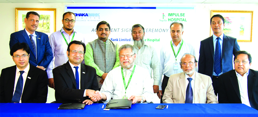 H M Mostafizur Rahaman, SVP of Dhaka Bank Limited and Prof. Dr. Ali Zaheer Al-Amin, Managing Director of Impulse Hospital Limited, exchanging a MoU signing document at the Bank's head office in the city recently. Under the deal, employees and cardholders