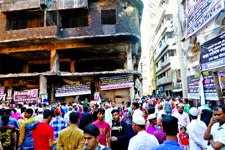 Bereaved families of Chawkbazar fire victims thronged in front of burnt Wahed Mansion at Churihatta area on Friday.