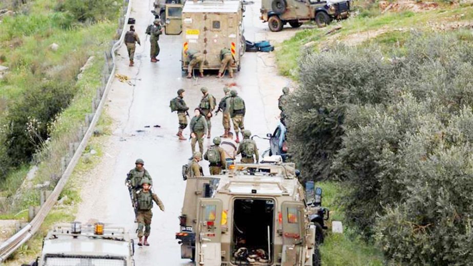 Israeli soldiers gather at the scene of an incident near Ramallah, in the Israeli-occupied West Bank.