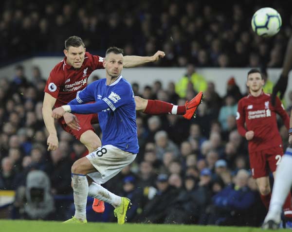 Liverpool's James Milner kicks the ball during the English Premier League soccer match between Everton and Liverpool at Goodison Park in Liverpool, England on Sunday.