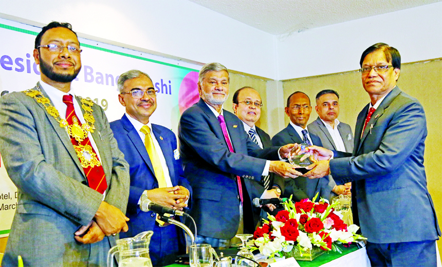 Hasne Alam, DMD of Islami Bank Bangladesh Limited, receiving the `Gold Remittance Award 2019' from Planning Minister Muhammad Abdul Mannan, for collecting highest remittance in the year-2018 conferred by the Centre for NRB at a hotel in the city on Satur