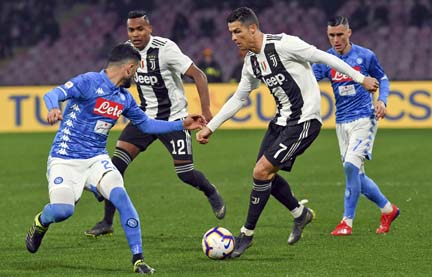Juventus' Cristiano Ronaldo takes on Napoli defense during the Serie A soccer match between Napoli and Juventus, at the San Paolo stadium in Naples, Italy on Sunday.