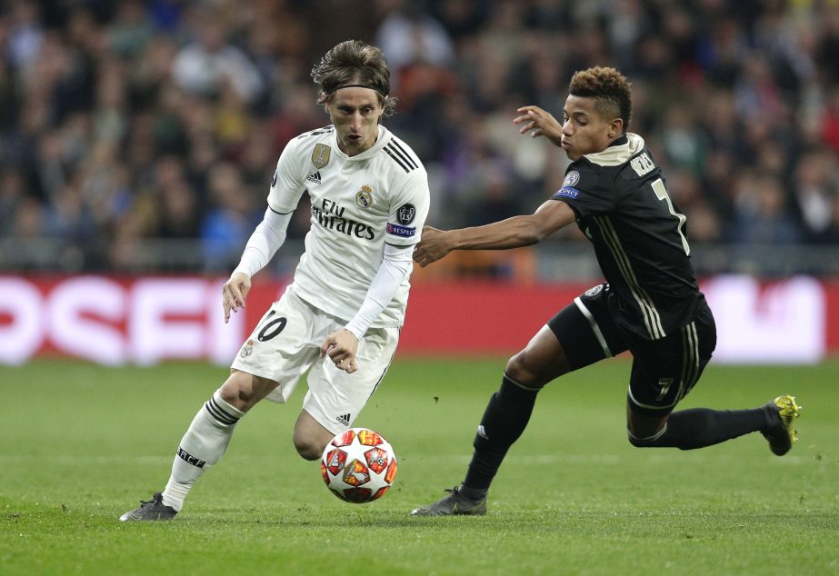 Ajax's David Neres fights for the ball against Real midfielder Luka Modric (left) during the Champions League soccer match between Real Madrid and Ajax at the Santiago Bernabeu stadium in Madrid, Spain on Tuesday.