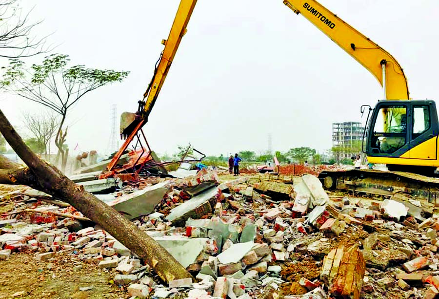 BIWTA authorities in a bid to turn the area into a link canal removing the sands after evicting the Amin Momin Housing Society at Bosila area in city's Mohammadpur. This photo was taken on Wednesday.