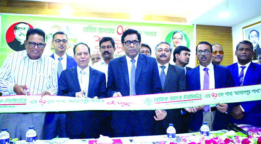 Md. Shaheb Ali Mridha, Director of BASIC Bank Limited, inaugurating its 70th branch at Jamalpur Sadar on Wednesday. Ahmed Hossain, Managing Director (Additional Charge), top executives and officials of the bank and local businessmen were also present.