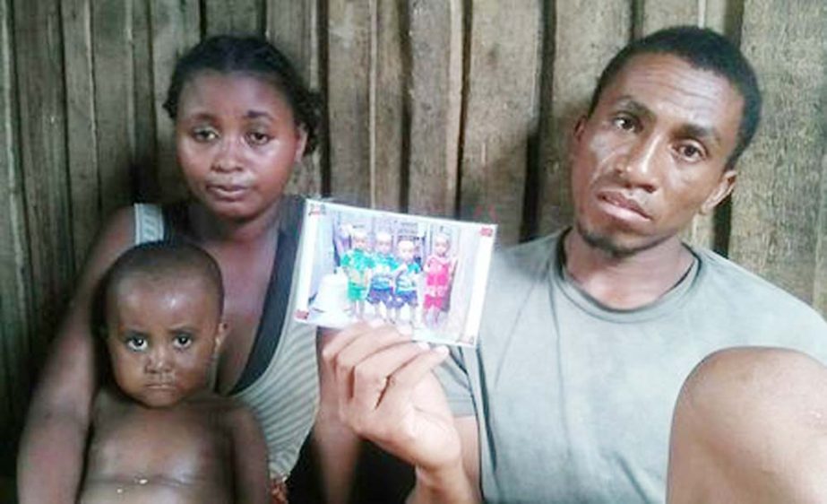 Malagasy fisherman Dada holds a photo of three cousins who died of measles one week apart in Fort Dauphin, Madagascar.