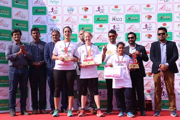 The winners of the Pran Mango Dhaka Women's Marathon with the chief guest former vice-chancellor of Dhaka University Professor Dr AAMS Arefin Siddique and the other guests and officials of Pran-RFL Group pose for a photo session at Concord Police Plaza P