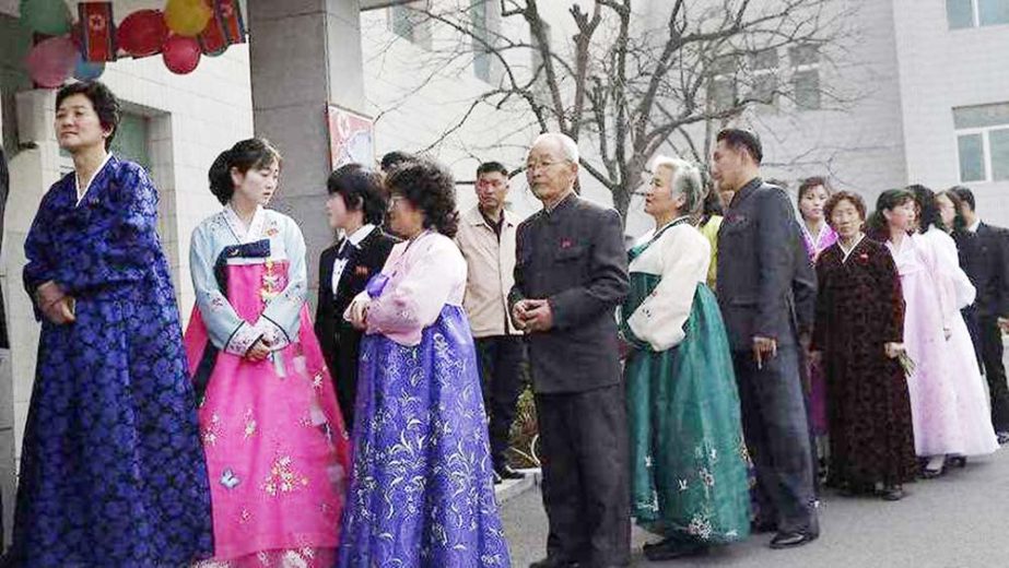 People line up to vote at a polling station in Pyongyang.