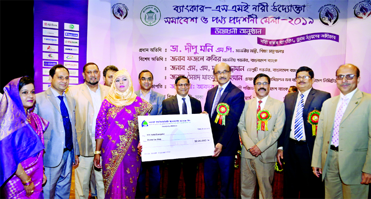 Bangladesh Bank's (BB) Governor Fazle Kabir, handing over a investment cheque to MS Nahid Enterprise, a client of First Security Islami Bank at at Banker SME Nari Uddokta Somabesh & Ponno Prodorshony Mela 2019 at Bangladesh Shishu Academy in the city on