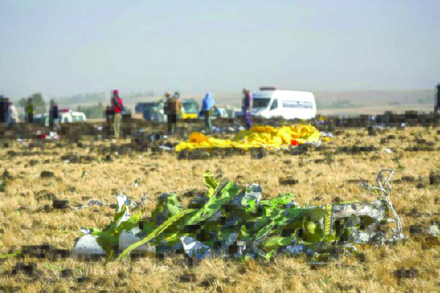 Parts of the plane wreckage with rescue workers at the crash site at Bishoftu, or Debre Zeit, outside Addis Ababa, Ethiopia, on Monday where Ethiopia Airlines Flight 302 crashed Sunday.