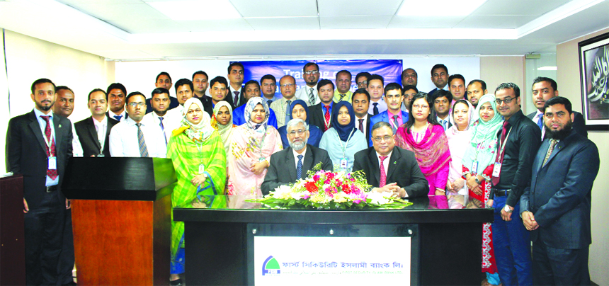 Md. Zahurul Haque, DMD of First Security Islami Bank Limited, poses for a photo session with the participants of a workshop on 'General Banking Operation' at the Banks Training Institute in the city on Tuesday. Muhammad Lutful Haque, Faculty of Institut