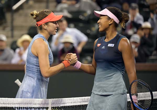 Belinda Bencic, of Switzerland (left) shakes hands with Naomi Osaka, of Japan at the BNP Paribas Open tennis tournament in Indian Wells, Calif on Tuesday.