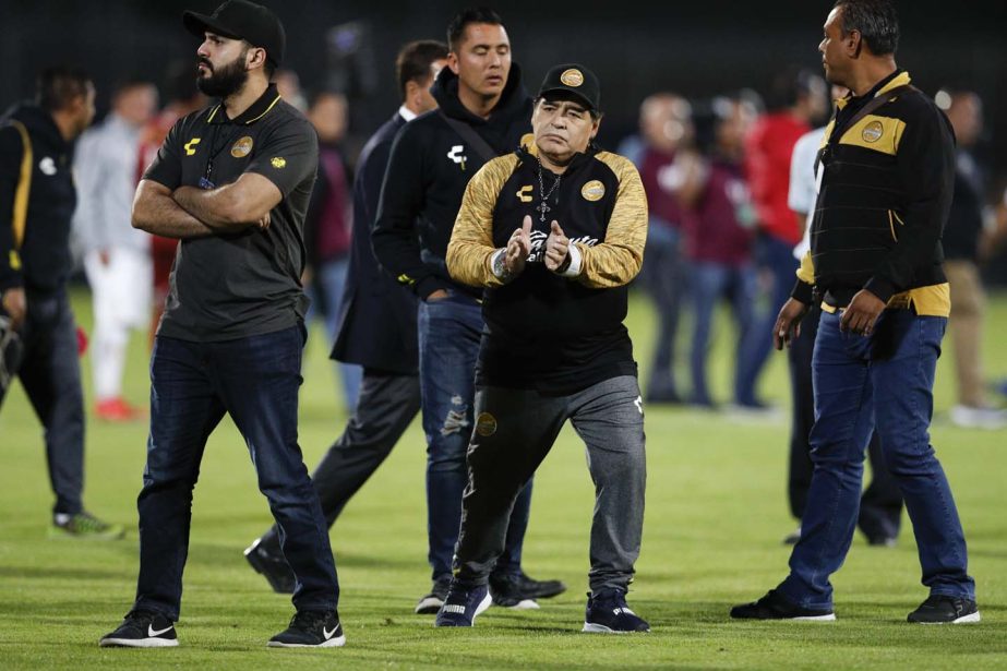 Dorados' Head Coach Diego Maradona (center) claps toward fans as he walks off the field after his team was defeated 3-0 by Pumas in their Copa MX quarterfinal match at Olympic University Stadium in Mexico City on Tuesday.