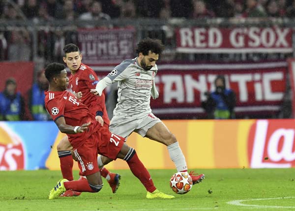 Liverpool forward Mohamed Salah (right) duels for the ball with Bayern defender David Alaba during the Champions League, round of 16, second leg, soccer match between Bayern Munich and Liverpool, at the Allianz Arena in Munich, Germany on Wednesday.