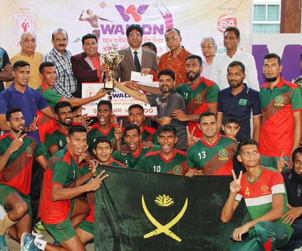 Members of Bangladesh Army Volleyball team, the champions of the Walton Independence Day Volleyball Competition with the guests and officials of Bangladesh Volleyball Federation pose for a photo session at Shaheed Nur Hossain National Volleyball Stadium o