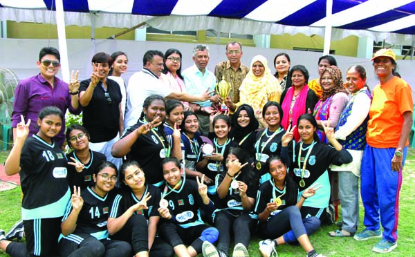 Members of Viqarunnisa Noon School & College, the champions of the Women's Handball Competition (Dhaka Metropolis) with the guests and officials of Dhaka District Women's Sports Association pose for a photo session at the Sultana Kamal Women's