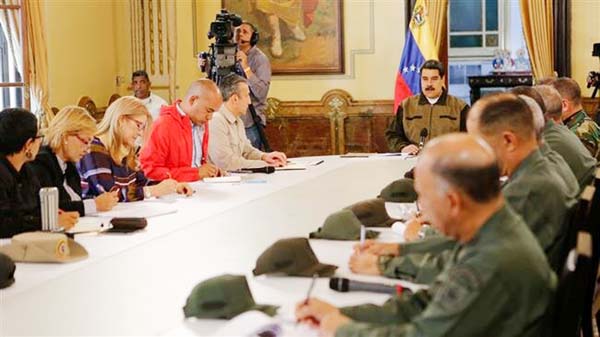 Venezuela's President Nicolas Maduro takes part in a video conference with members of the government and military high command members in Caracas on Friday.