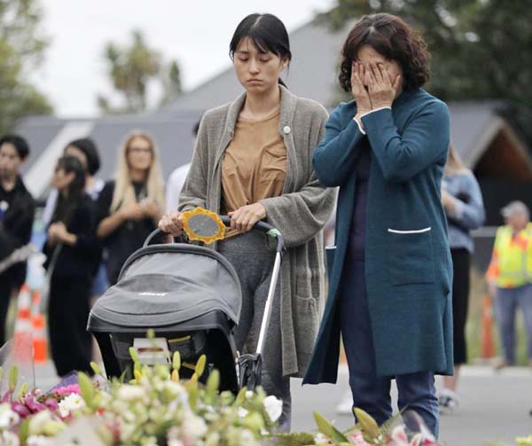 Mourners pay their respects at a makeshift memorial near the Al Noor mosque in Christchurch, New Zealand on Saturday.