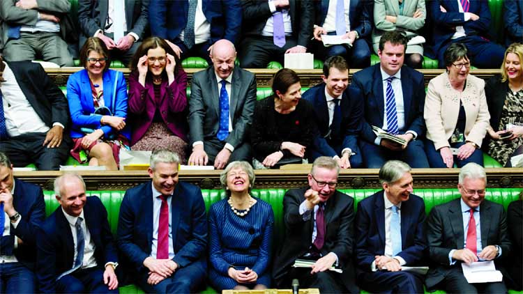 UK Parliament, Britain's Prime Minister Theresa May, first row centre, laughs during the Brexit debate in the House of Commons in London.