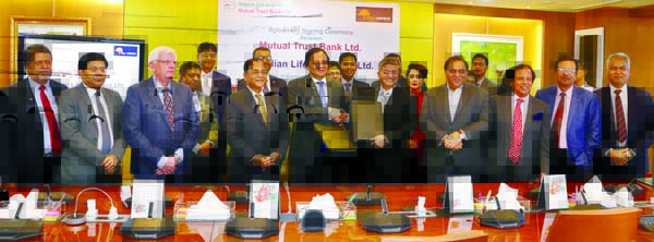 M M Monirul Alam, Managing Director of Guardian Life Insurance Limited and Anis A Khan, Managing Director of Mutual Trust Bank (MTB) Limited, exchanging an agreement signing document at the Bank's head office in the city recently. Under the deal, employe