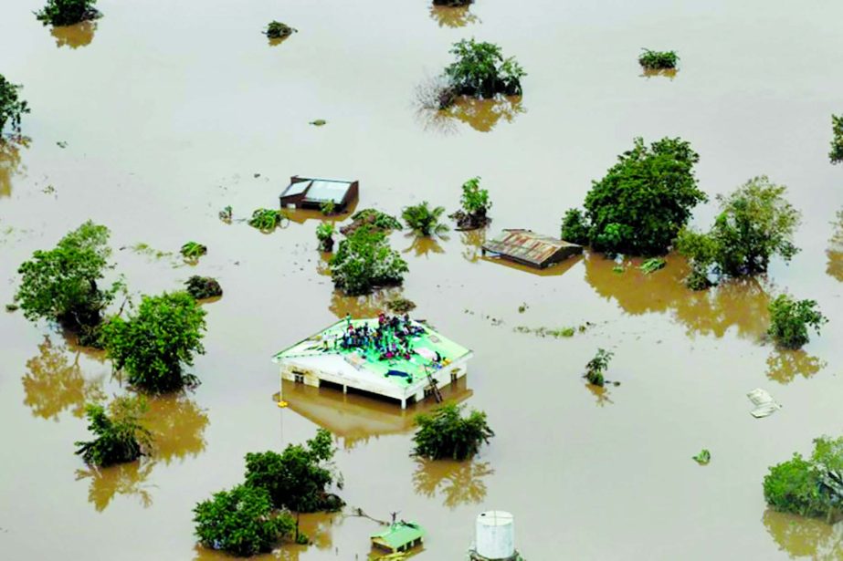Inland sea: Helicopters are trying to save people stranded on rooftops and in trees.
