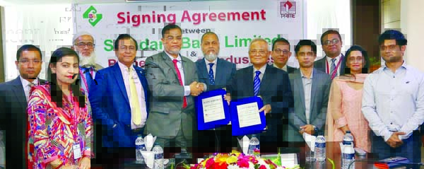 Md. Motaleb Hossain, DMD of Standard Bank Limited and M A Awal, Chairman of Prime Group of Industries, exchanging an agreement signing document at the Bank's head office in the city on recently. Under the deal, around five thousand employees of the group