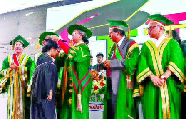 Education Minister Dr Dipu Moni conferring gold medal to a graduate in the fifth convocation of International University of Business Agriculture and Technology (IUBAT) held at the Uttara Sector-14 Playground on Thursday.