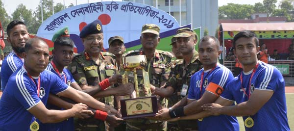 Area Commander of Savar Area and General Officer Commanding of 9 Infantry Division Major General Mohammad Akbar Hossain handing over the trophy to the members of 33 Infantry Division Hockey team, which emerged as the champions of Bangladesh Army Hocke