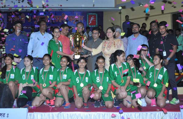 Scholastica, the champions of the Girls' Division of the Panam Group Dhaka Metropolis School Volleyball Competition with the guests and officials of Bangladesh Volleyball Federation pose for a photo session at the Shaheed Suhrawardy Indoor Stadium in the