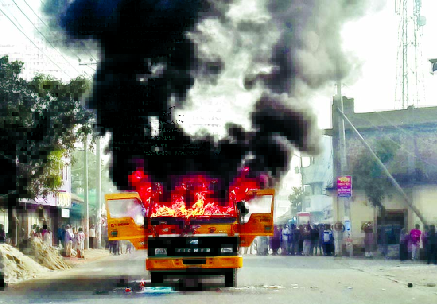 Killer van torched: Agitated people put up barricade in the road and set afire a vehicle on the spot when a student of Dhukuria Technical College in Kamarkhand Upazila of Sirajganj was crashed to death on Thursday.
