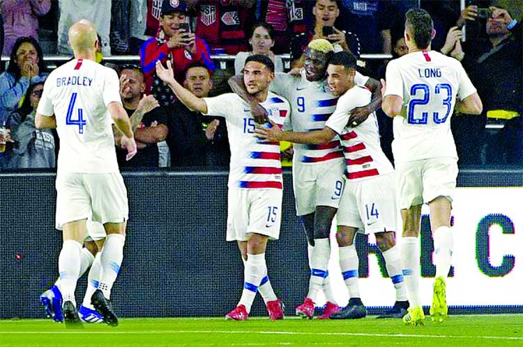 United States forward Gyasi Zardes (9) is congratulated by teammates after scoring a goal during the second half of an international friendly soccer match against Ecuador in Orlando, Fla on Thursday.