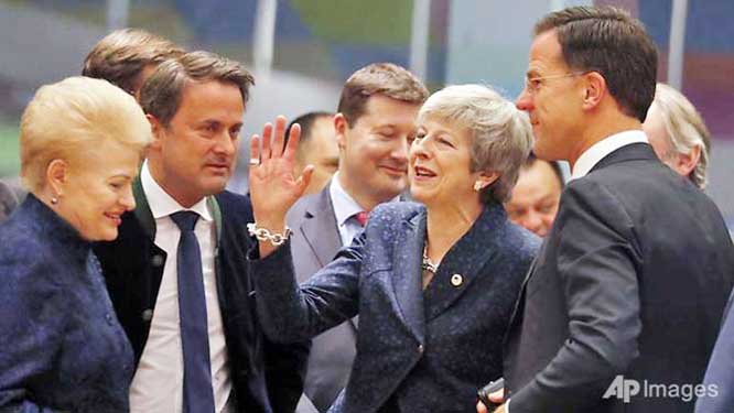 British Prime Minister Theresa May (centre) speaks with Dutch Prime Minister Mark Rutte (right) and Lithuanian President Dalia Grybauskaite (left) during a round table meeting at an EU summit in Brussels.