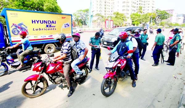 Motor bikes and vehicles being checked at different check points in city as Traffic Discipline Week continued. This photo was taken from Kakrail intersection point on Sunday.