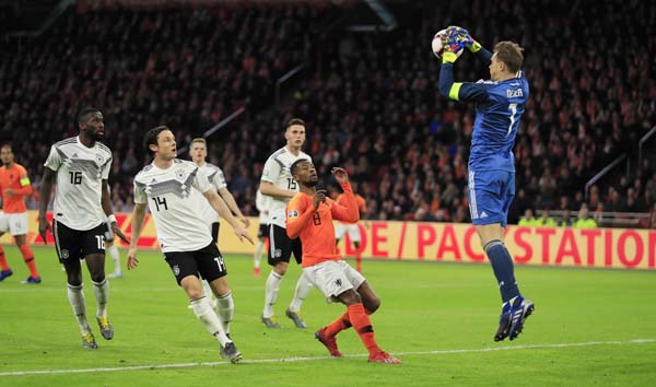 Germany goalkeeper Manuel Neuer (right) stops the ball during the Euro 2020 group C qualifying soccer match between Netherlands and Germany at the Johan Cruyff Arena in Amsterdam on Sunday.