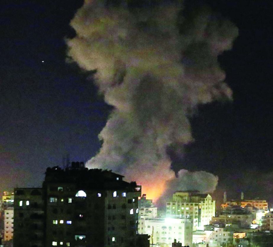 Smoke is seen rising following an Israeli air strike on Gaza city.