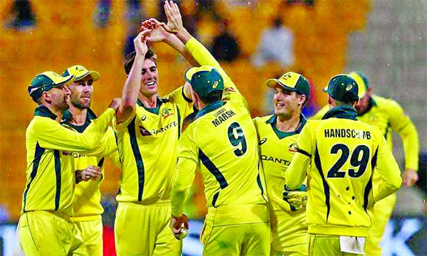 Australian cricketer Patrick Cummins (3rd from left) celebrates with his teammates after dismissal of Pakistani cricketer Haris Akmal during the third One Day International (ODI) cricket match between Pakistan and Australia at Sheikh Zayed Stadium in Abu