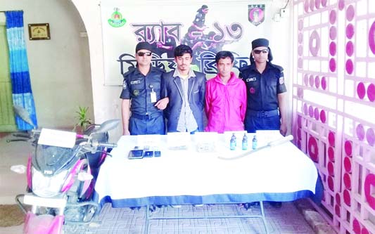 NILPHAMARI: Two persons were arrested by members of RAB-13 with local weapon and mobile phones from Dandpai Village in Debiganj Upazila on Wednesday.