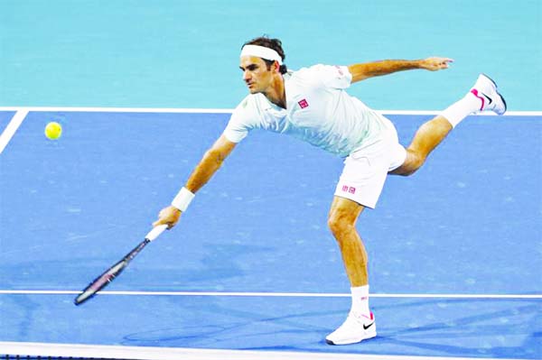 Roger Federer of Switzerland, returns to Kevin Anderson of South Africa, during a quarterfinal in the Miami Open tennis tournament in Miami Gardens, Fla on Thursday.