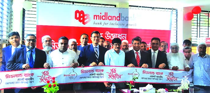 Md. Ahsan-uz Zaman, Managing Director of Midland Bank Limited, inaugurating its Agent Banking Centre at Shibchar Thana Sadar in Madaripur recently. Md. Ridwanul Haque, Head of Retail Distribution of the Bank and local elites were also present.